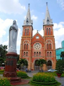 Notre Dame Cathedral in Ho Chi Minh City, Vietnam, with iconic red brick facade and twin bell towers